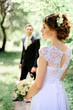 © IVASHstudio - young and beautiful bride and groom standing in the garden