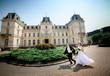 © IVASHstudio - young and beautiful bride and groom walks near manor