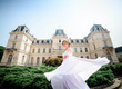 © IVASHstudio - young and beautiful bride in white dress walks near manor