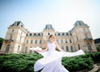 © IVASHstudio - young and beautiful bride in white dress walks near manor