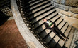 © IVASHstudio - young and handsome groom in a black suit lying on the stairs