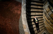 © IVASHstudio - young and handsome groom in a black suit lying on the stairs