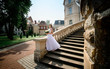 © IVASHstudio - young and beautiful bride in white dress standing on the stairs