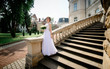 © IVASHstudio - young and beautiful bride in white dress standing on the stairs