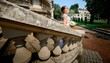 © IVASHstudio - young and beautiful bride in white dress standing on the stairs