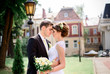 © IVASHstudio - young and beautiful bride and groom standing near manor