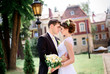© IVASHstudio - young and beautiful bride and groom standing near manor