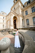 © IVASHstudio - young and beautiful bride in white dress standing near manor