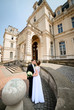 © IVASHstudio - young and beautiful bride and groom standing near manor