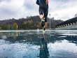 © Giorgio Pulcini - Man running on athletic track in a rainy day