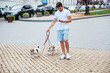 © Drobot Dean - Handsome young man with his dogs on a walk