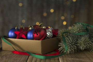 A box of Christmas decorations on an old wooden table.