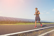 © boonchok - handsome man running on road with solar power plant in morning ;