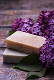 Fototapeta Lawenda - Spa set, handmade soap, a bouquet of lilacs on a wooden background