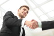 © ASDF - Businessman by handshake invites to cooperation.