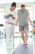 © auremar - male patient standing with a physiotherapist