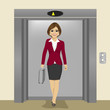 young beautiful businesswoman with briefcase coming out of office building elevator