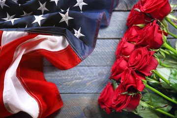 Wall Mural - Roses and USA flag on wooden background. Symbol of America