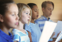 Schoolchildren Singing Song On Music Lesson