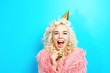 © Africa Studio - Funny girl in birthday hat on blue background