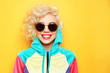 © Africa Studio - Fashion girl in sportswear on yellow background