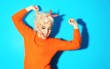 Portrait of funny emotional girl on blue background