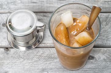 Vietnamese iced coffee with condensed milk, cafe sua da on a woo