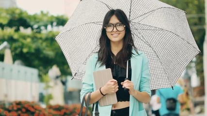 Wall Mural - Beautiful asian young woman with tablet in city street