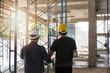 © jat306 - Engineer and Architect working at Construction Site with bluepri