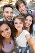 © Africa Studio - Happy friends taking selfie on street