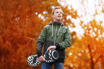 Poster - Teenager with gyroscooter in park on autumn day