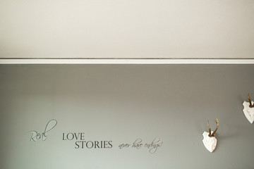 Wall Mural - Lettering 'Love stories' printed on grey wall