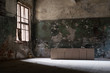 © azbota - damaged, dirty room of the old abandoned building, empty boxes in the middle