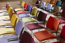 Colourful Chairs Standing Neatly In Rows.