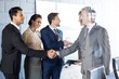 © WavebreakMediaMicro - Businessman shaking hands with team