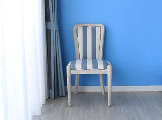 Wall Mural - chair on wooden floor with curtain as background