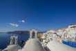 © Netfalls - Scenic view of traditional cycladic white houses and blue domes in Oia village, Santorini island, Greece