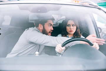 Irritated woman and man in car