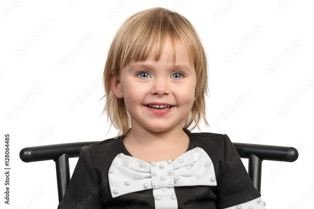 Smiling little girl on a chair Stock Photo | Adobe Stock