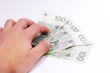 © Tomasz - people, business, finances and money concept - close up of businessman hands holding polish money zloty (pln), paying