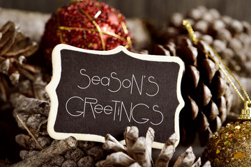 Poster - text seasons greetings, pine cones and baubles