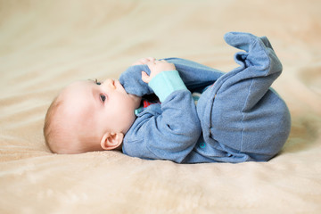 little cute cheerful baby on bed