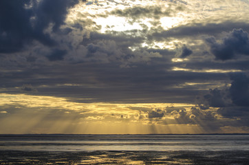 Wall Mural - Sunset light through the clouds from the beach, Bay of Saint Mic