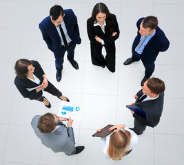 business people with their hands together in a circle