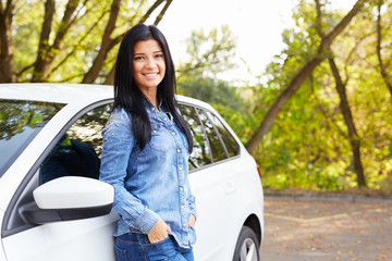 Woman standing by her car