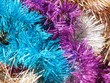 © ANGHI - Multicolored shiny Christmas garland, festive tinsel background