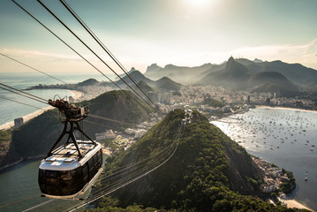 Wall Mural - View of Rio de Janeiro city from the Sugarloaf Mountain by sunset with a cable car approaching