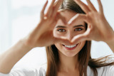 Fototapeta  - Beautiful Happy Woman Showing Love Sign Near Eyes.