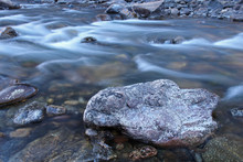Icy Water Flows Over Rocks In The Poudre River In Colorado