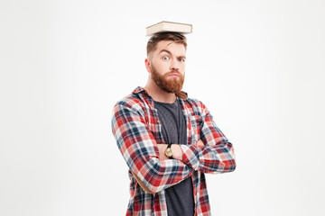 Wall Mural - Young bearded man with book on his head having fun